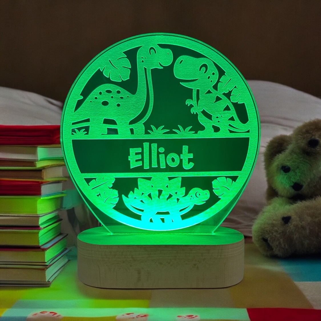 Dino lampe med navn og grøn LED lys. På træfod.